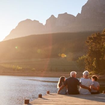 Grandchildren,With,Grandparents,Sitting,On,Wooden,Jetty,By,Lake Wealth Management Resources